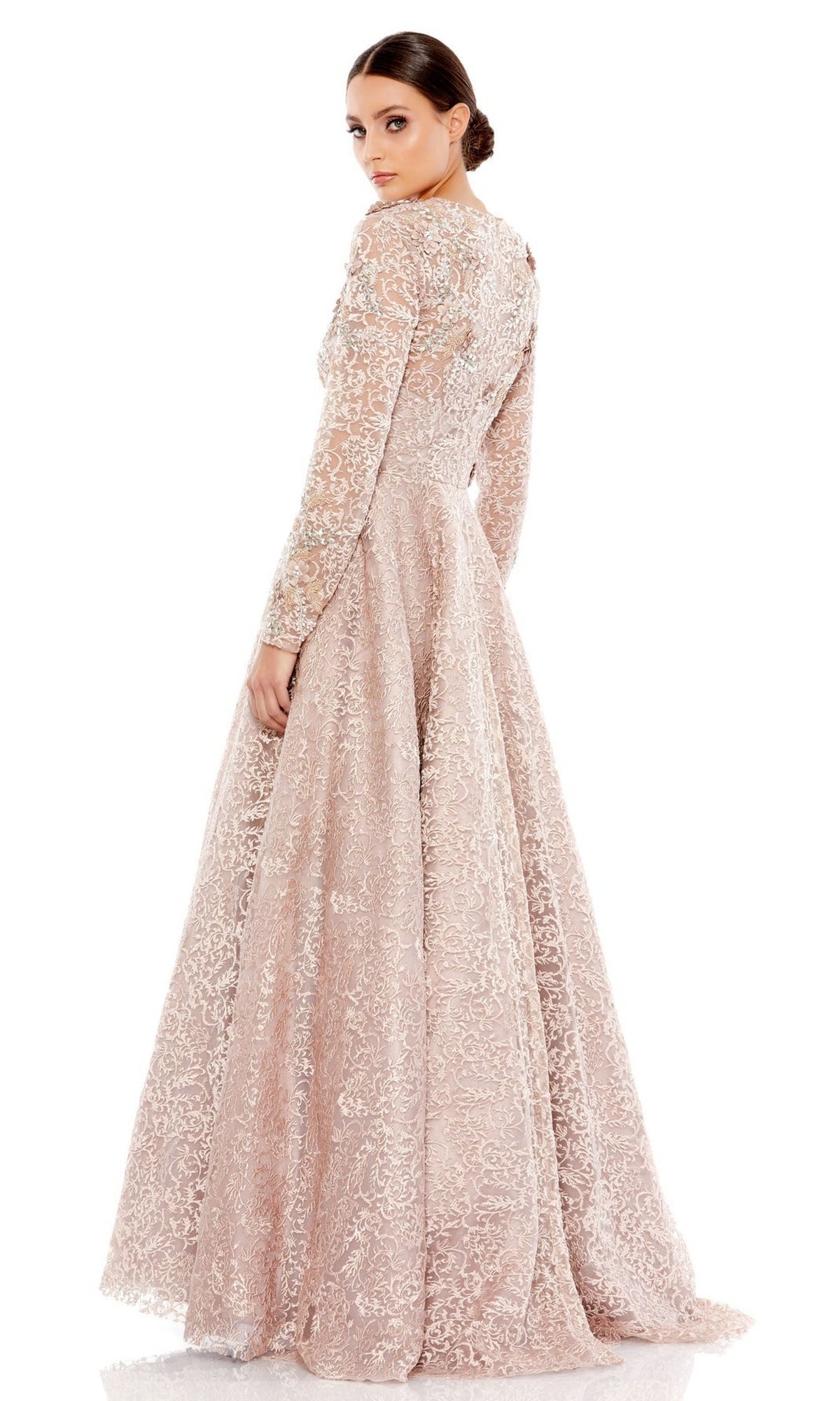 A woman in a long sleeve mocha Mac Duggal 11121 formal gown stands facing away, looking over her shoulder against a white background.